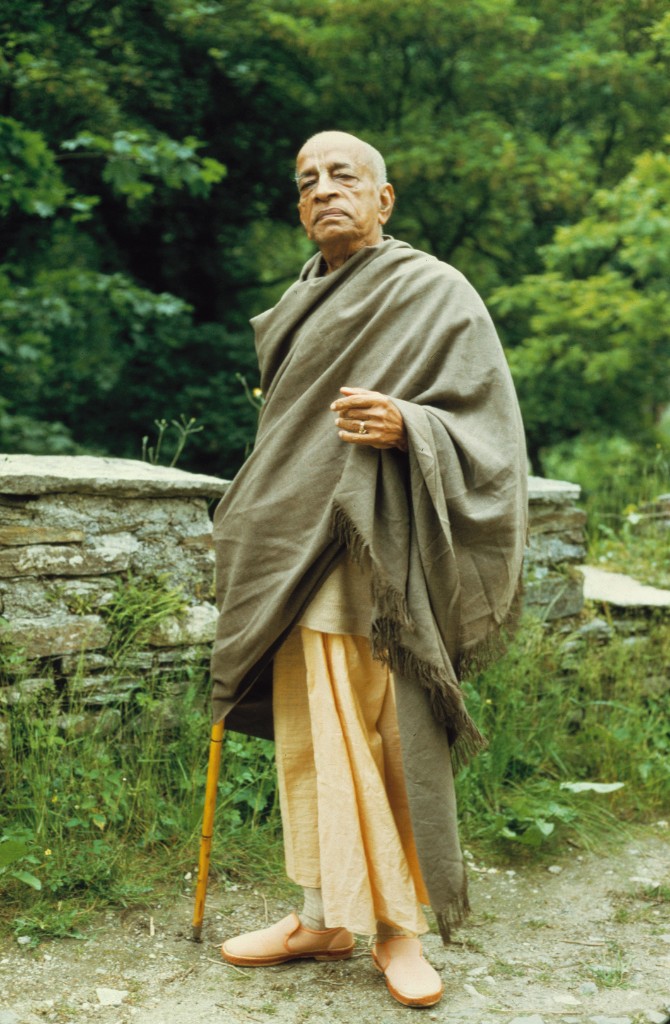 Srila Prabhupada walking with walking stick in nature